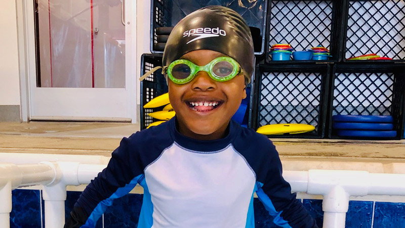 Four-year-old Braxton having fun in the pool during his swim lesson.